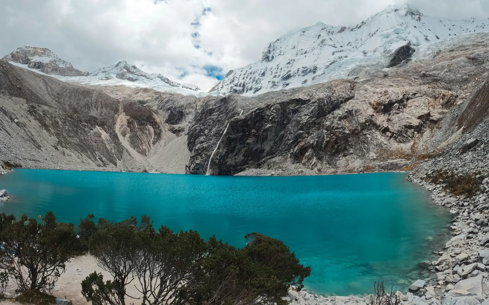 A turquoise glacial lake below a snow-capped Andean peak at Humantay